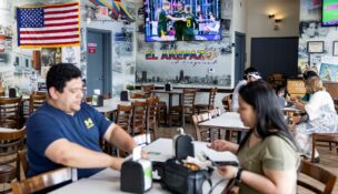 A U.S. flag hangs inside El Arepazo restaurant in Doral, Florida, April 1, 2026. (REUTERS/Eva Marie Uzcategui)