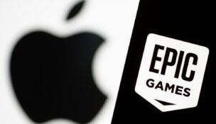 A smartphone with the Epic Games logo is seen in front of an Apple logo in this illustration taken May 2, 2021. (REUTERS/Dado Ruvic/Illustration)