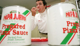 Papa John's founder John Schnatter tastes a spoonful of pizza sauce in 1997. (USA TODAY Network via Reuters Connect)