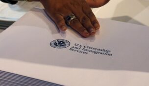 Information packs are distributed by the U.S. Citizenship and Immigration Services following a citizenship ceremony at the John F. Kennedy Presidential Library in Boston on July 18, 2018. (REUTERS/Brian Snyder/File Photo)