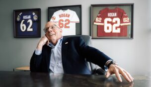 Former Maryland Gov. Larry Hogan poses for a photo in his Annapolis office with jerseys of local sports teams hanging behind him on May 14, 2026. (Maxine Wallace/The Washington Post)