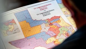 State Representative Matt Morgan (R-TX) holds a map of the new proposed congressional districts in Texas, during a legislative session as Democratic lawmakers, who left the state to deny Republicans the opportunity to redraw the state's 38 congressional districts, begin returning to the Texas State Capitol in Austin, Texas, on Aug. 20, 2025. (REUTERS/Sergio Flores/File Photo)