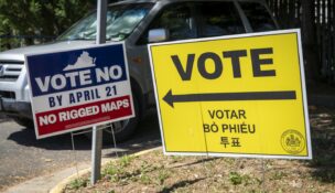 A sign encouraging people to vote against a Virginia redistricting ballot measure at a Falls Church polling center on April 21, 2026. (Maxine Wallace/The Washington Post)