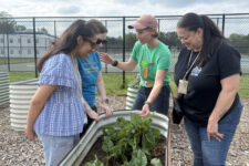 Charles Koiner Conservancy for Urban Farming Executive Director Kate Medina, and Loiederman school community liaison Carol Fernandez, right, welcome teachers from nearby Weller Road Elementary to explore the Farm Hub for a potential field trip. (Photo by Rosanne Skirble/Maryland Matters)