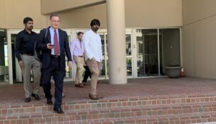 With his clients following behind, Shaun Clarke, an attorney representing seafarers from two ships managed by the same firm as the Dali, leaves the U.S. District Court for Maryland's courthouse in Baltimore following a scheduling hearing.