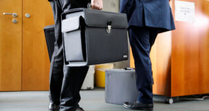 People with briefcases come out of a boardroom in this file photo dated July 29, 2020. (REUTERS file photo/Axel Schmidt)