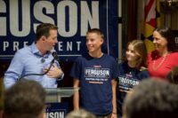 Senate President Bill Ferguson (D-Baltimore City) is joined on stage by his wife, Lea, and their children, Caleb and Cora, at an election night victory party Tuesday, after Ferguson survived one of his biggest political challenges in years. (Photo by Christine Condon/Maryland Matters)