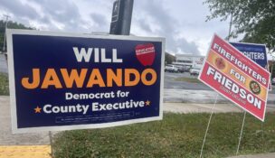 Campaign signs for Montgomery County Council members Andrew Friedson and Will Jawando outside Rockville High School on Tueday. (Photo by Mayah Nachman/Maryland Matters)