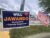 Campaign signs for Montgomery County Council members Andrew Friedson and Will Jawando outside Rockville High School on Tueday. (Photo by Mayah Nachman/Maryland Matters)