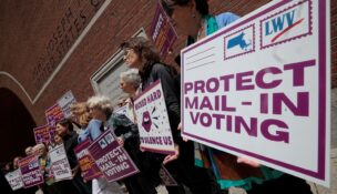 Supporters gather outside the federal courthouse after a hearing in a lawsuit brought by a coalition of Democratic state attorneys general seeking to block President Donald Trump's executive order tightening rules on mail-in voting, in Boston on June 2, 2026. (REUTERS/Brian Snyder)