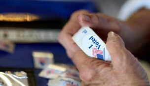 A poll worker holds a roll of 'I voted' stickers at an El Dorado County polling station during California's special election on Proposition 50 in El Dorado Hills, California, on Nov. 4, 2025. (REUTERS/Fred Greaves/File Photo)