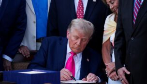 President Donald Trump signs the sweeping spending and tax legislation, known as the "One Big Beautiful Bill Act," at the White House in Washington on July 4, 2025. (REUTERS/Ken Cedeno)