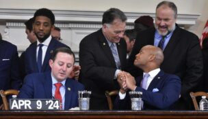 Gov. Wes Moore and Sen. Johnny Ray Salling shake hands at the signing of the PORT Act in 2024 after working closely to respond to the collapse of the Francis Scott Key Bridge. (Kiersten Hacker/Capital News Service)