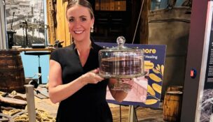 Adrienne Prout shows a Smith Island cake that was auctioned at the American Cancer Society's third annual An Evening of Hope event at the Baltimore Museum of Industry on Nov. 6, 2025. (Vivienne Stearns-Elliott)
