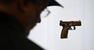 A person looks at a gun on display during the National Rifle Association’s (NRA) Annual Meetings and Exhibits in Houston on April 19, 2026. (REUTERS/Callaghan O'Hare)