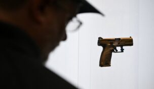 A person looks at a gun on display during the National Rifle Association’s (NRA) Annual Meetings and Exhibits in Houston on April 19, 2026. (REUTERS/Callaghan O'Hare)