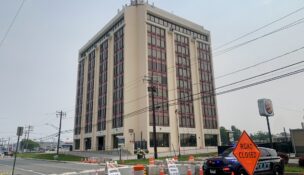 Anne Arundel County Police block off the collapse zone around Empire Towers, the 10-story office building in Glen Burnie that was condemned as unsafe last week after being compromised during unpermitted construction in the garage.