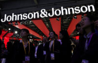 People gather next to a logo of Johnson & Johnson at the company’s booth at the 8th China International Import Expo (CIIE) in Shanghai, China, November 6, 2025. (REUTERS/Maxim Shemetov)