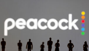 Toy figures of people are seen in front of the displayed Peacock logo, in this illustration taken January 20, 2022. (REUTERS/Dado Ruvic/Illustration)