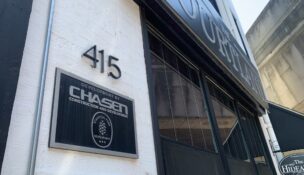 A sign at The Courtland, a 15-unit former Chasen Cos. apartment building in downtown Baltimore, bears the name of the collapsed real estate business.