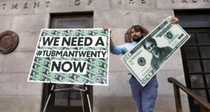 Capitol Hill staff member places signs before a news conference by House Majority Leader Steny Hoyer (D-MD) on Treasury Secretary Steve Mnuchin's decision to indefinitely delay putting famous abolitionist Harriet Tubman on the new $20 bill, on the steps of the Treasury Department in Washington on June 27, 2019. (REUTERS/Yuri Gripas/File Photo)
