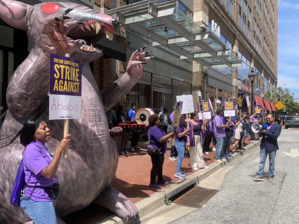 Security workers at the Abacus Corporation who patrol Baltimore's Harbor East neighborhood walked off the job Friday in their second unfair labor practice strike of the year.