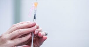 A nurse readies a syringe during a free vaccination event for students and faculty at a Kentucky high school. The Maryland Department of Health announced that 10 Maryland FQHCs have joined the state's vaccine program for uninsured adults. (USA TODAY Network)
