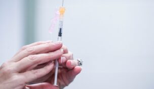 A nurse readies a syringe during a free vaccination event for students and faculty at a Kentucky high school. The Maryland Department of Health announced that 10 Maryland FQHCs have joined the state's vaccine program for uninsured adults. (USA TODAY Network)