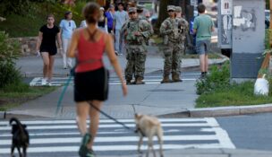 National Guard troops stand back-to-back as they wait to cross the street while on patrol in Washington on June 24, 2026. (REUTERS/Leah Millis)
