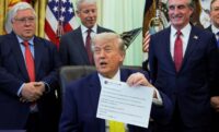 President Donald Trump shows a printout of his Truth Social post as he delivers remarks to reporters in the Oval Office at the White House in Washington on June 4, 2026. (REUTERS/Jonathan Ernst/File Photo)